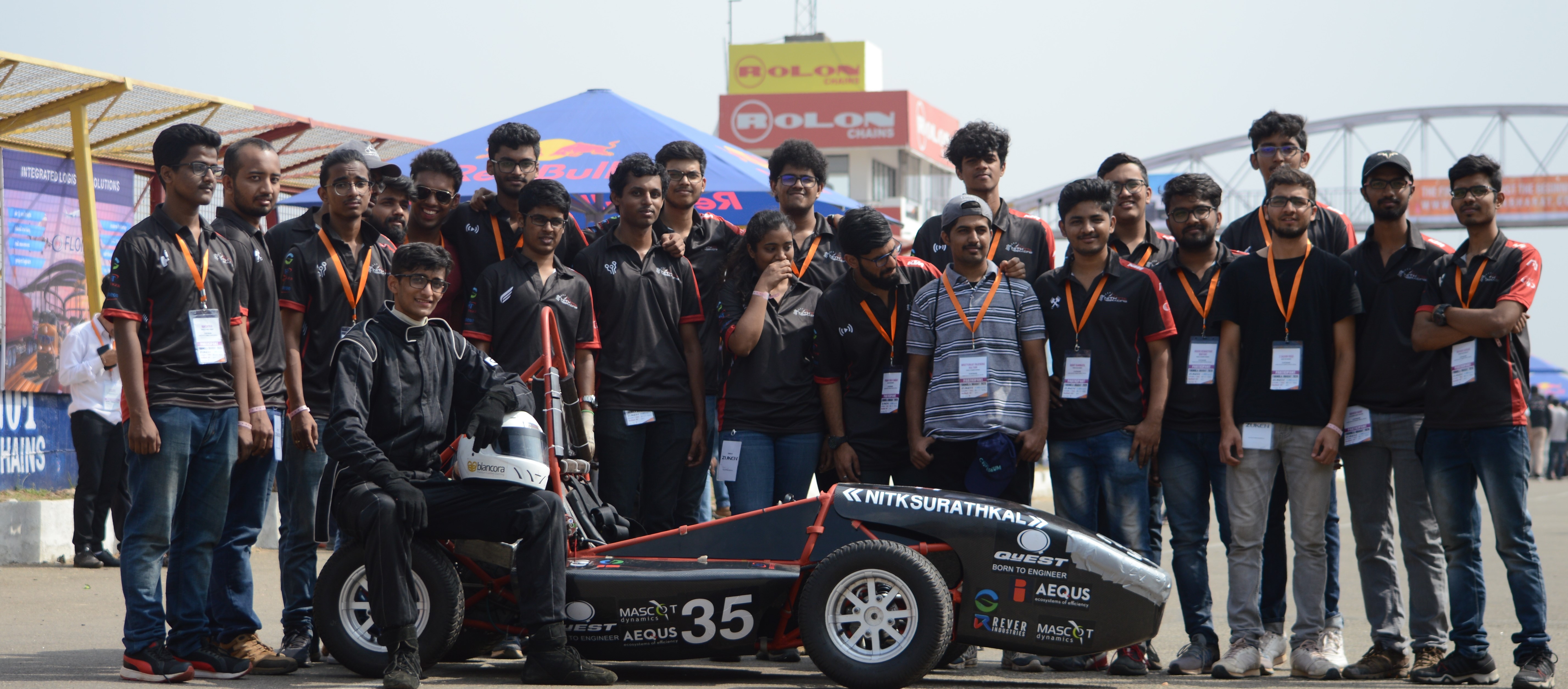 image of NITKRacing members with their car